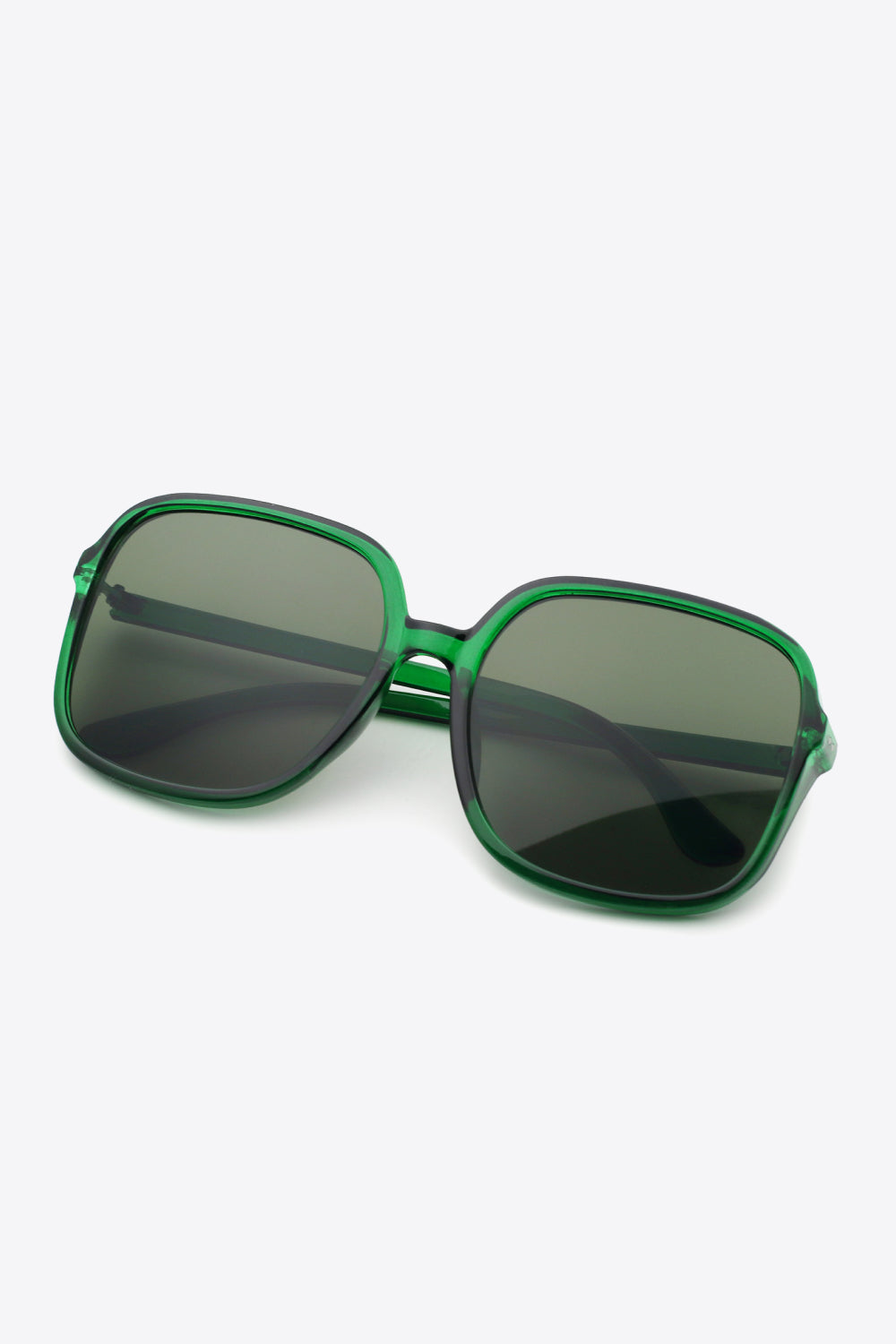 Oversized square sunglasses with green polycarbonate frame and UV400 protection.