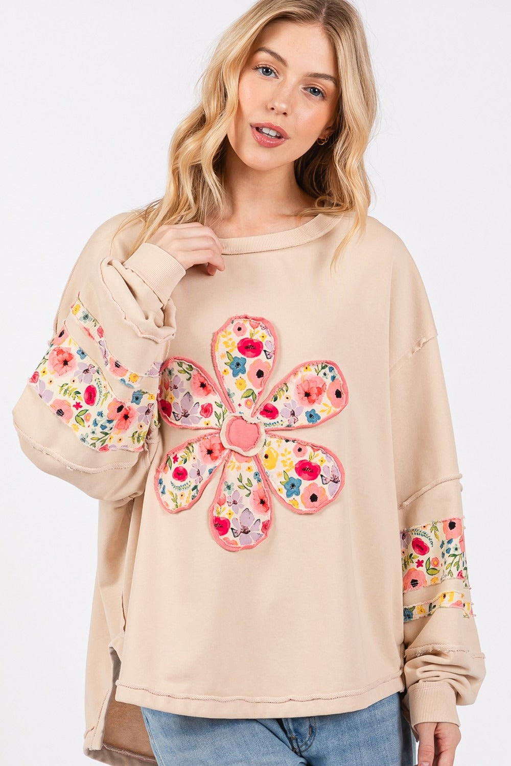 Daisy Patch Applique Long Sleeve Sweatshirt with floral design and exposed seam.