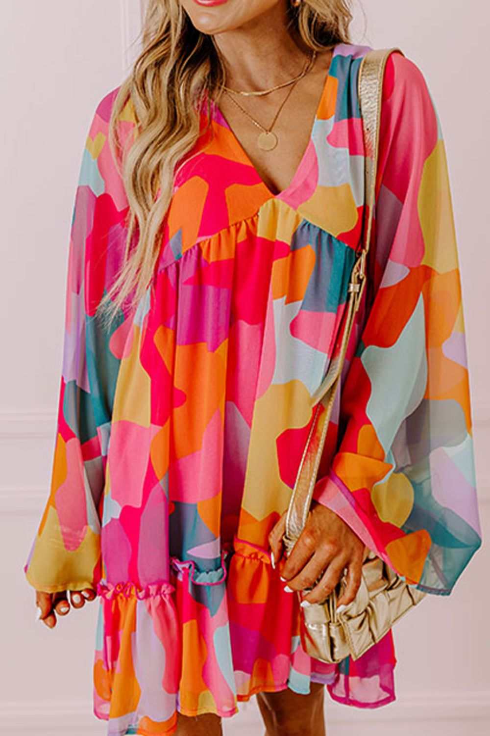 Ruffle hem color block V-neck long sleeve mini dress, vibrant and stylish.