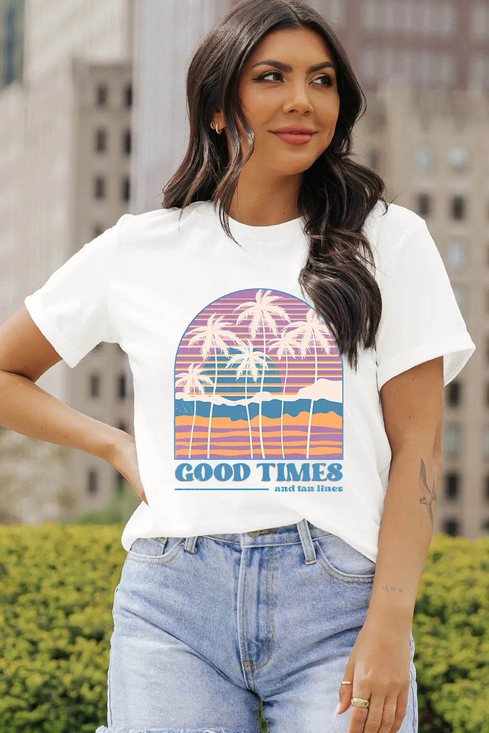 Woman wearing Good Times Graphic T-Shirt with palm tree design and text.