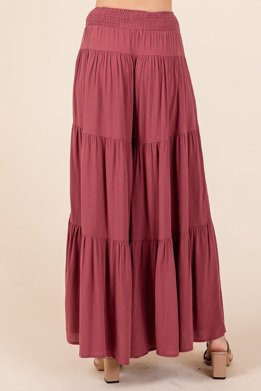 Tier detail smocked elastic waist wide leg pants in lightweight crepe with side pockets.