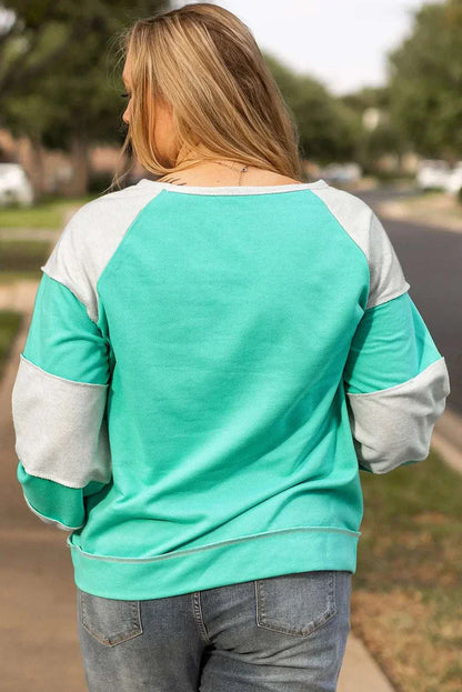 Plus size exposed seam color block long sleeve sweatshirt in green and gray.