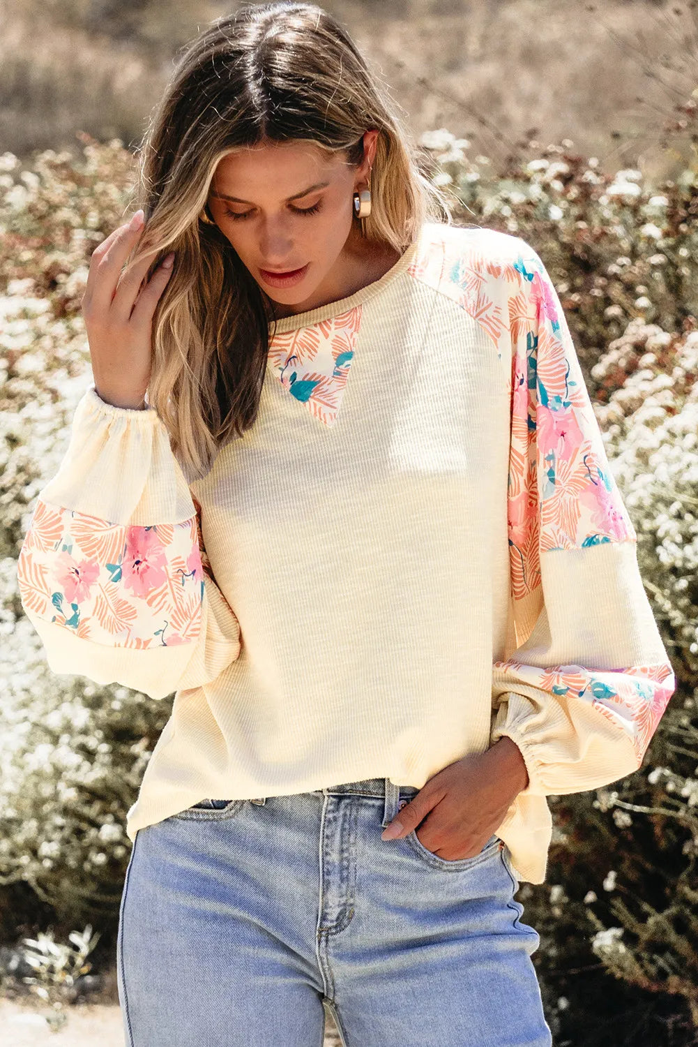 Printed round neck balloon sleeve blouse with floral design.