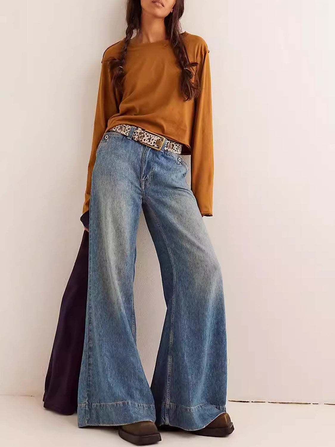 Women's round neck long sleeve cropped tee in brown, paired with high-waist wide-leg jeans.