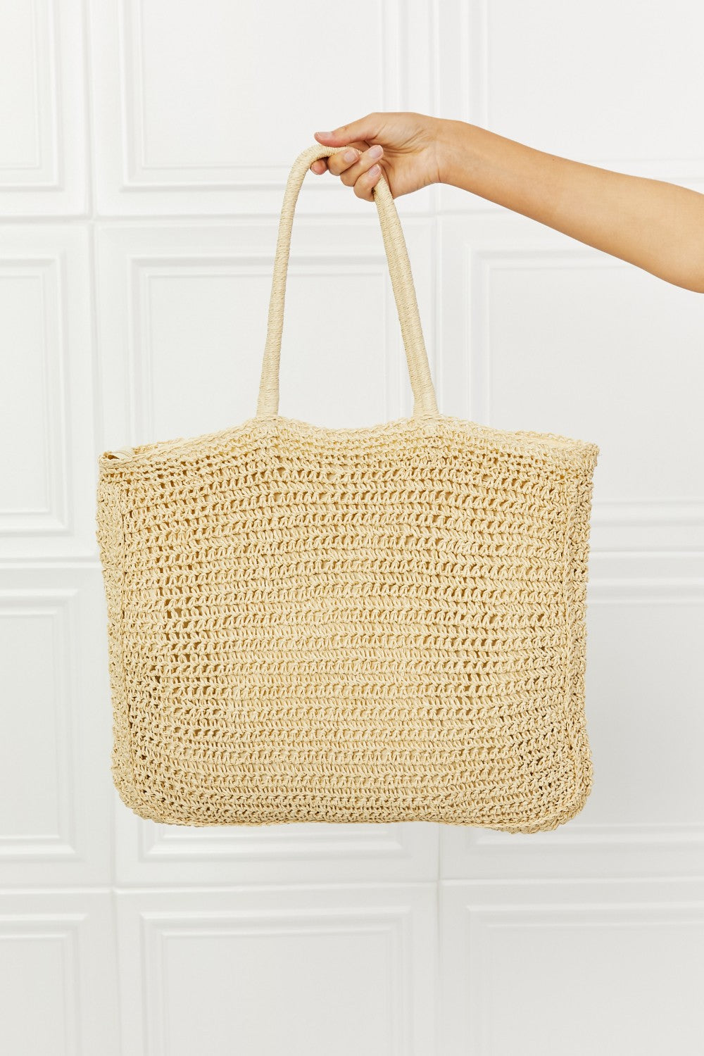 Large straw tote bag with crochet design, zipper closure, and long straps.