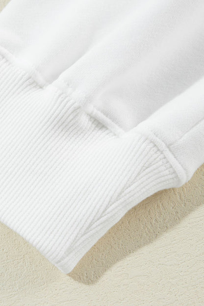 Close-up of white ribbed cuff on US Flag Long Sleeve Sweatshirt.