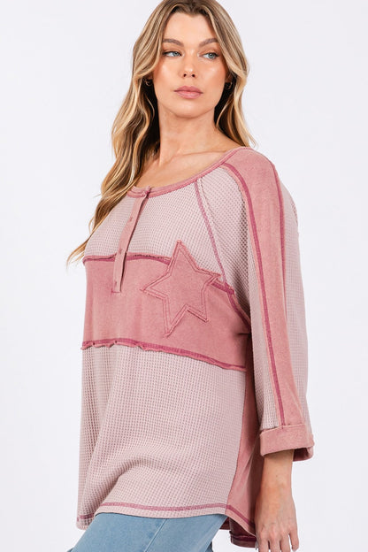 Star applique patch exposed seam waffle knit top with trendy design.