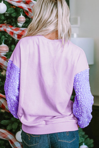 Sequin round neck long sleeve sweatshirt with purple sequin sleeves and a light pink body.