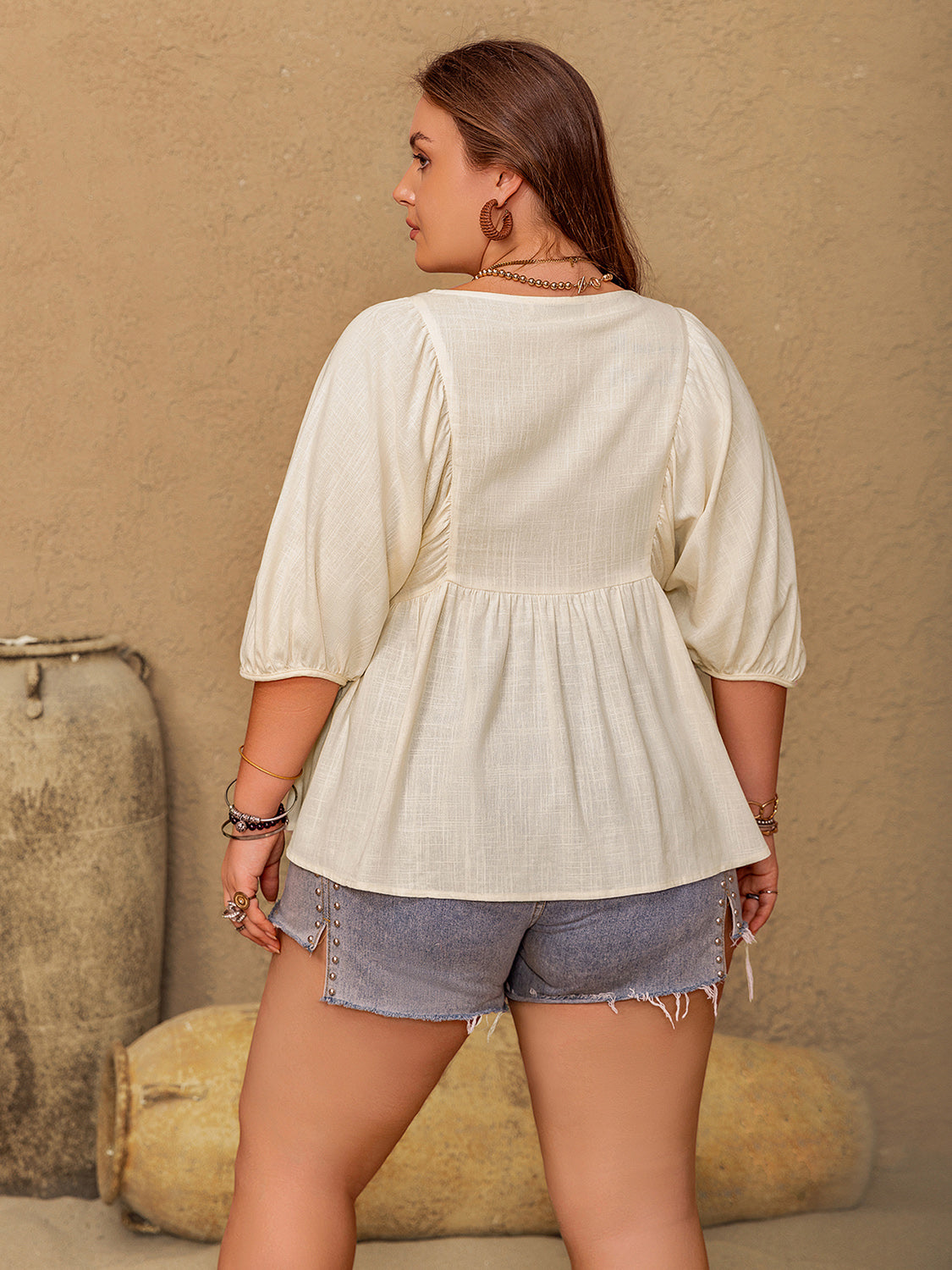 Plus size peplum V-neck half sleeve blouse in viscose and linen, ruched design, shown from back.