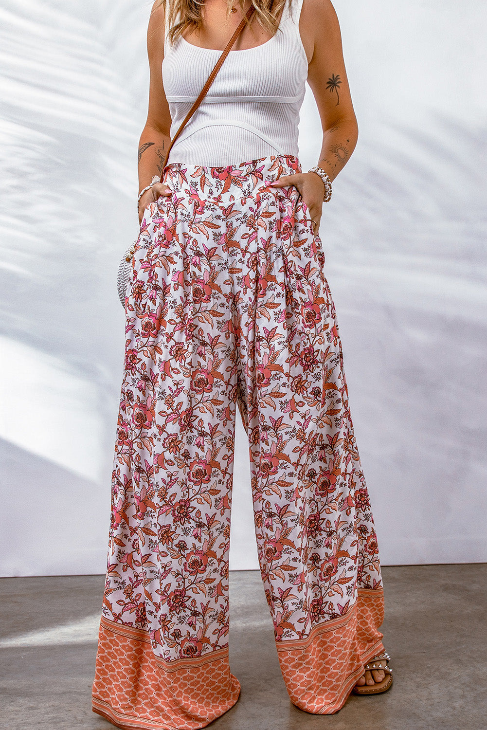 Bohemian pleated wide leg pants with floral pattern and straight hem.