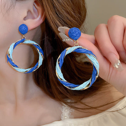 Twisted contrast grass vine earrings in blue and white tones, made of alloy and grass vine.