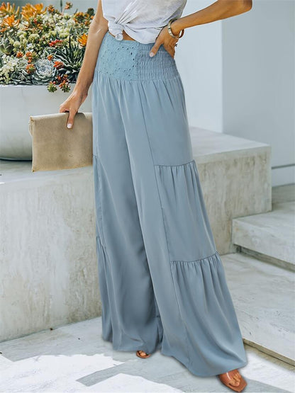 Smocked high waist pants in polyester, light blue, wide leg style, casual setting.