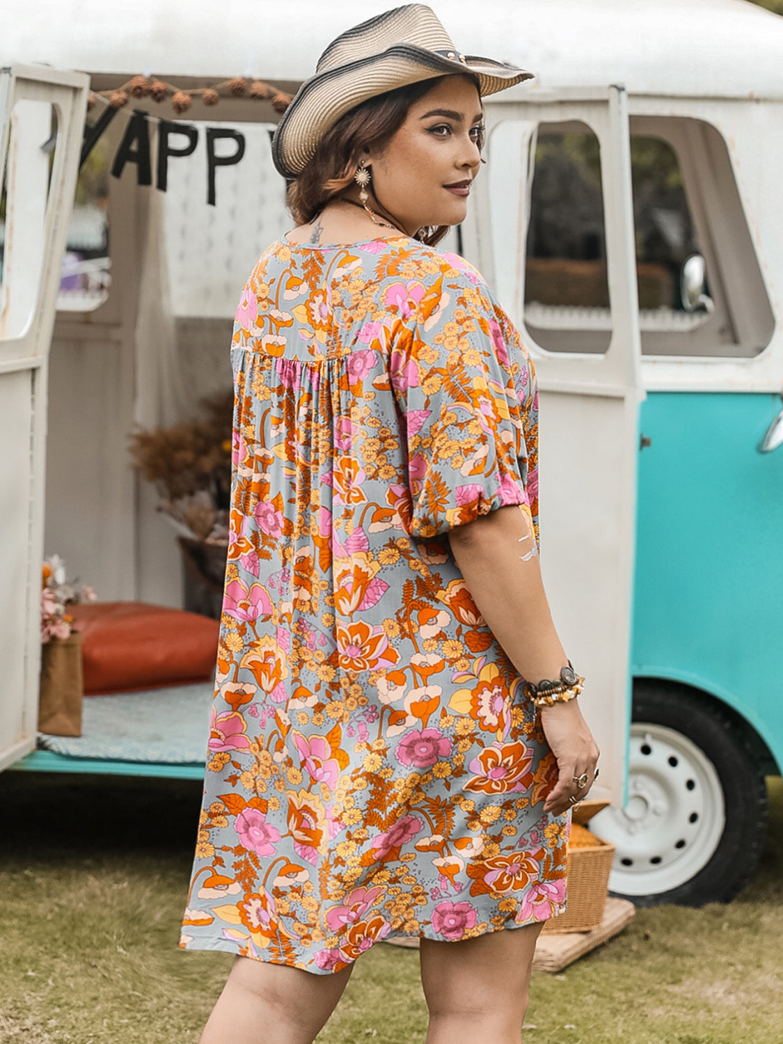 Plus Size Ruched Printed Half Sleeve Mini Dress in floral pattern.