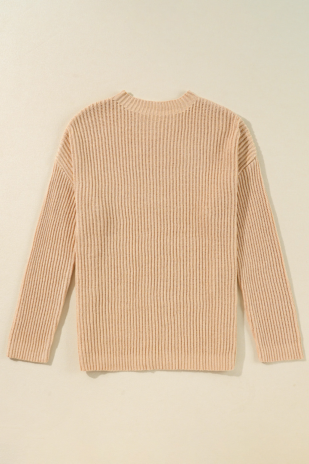 Side slit round neck long sleeve sweater in beige, ribbed texture, slightly stretchy.