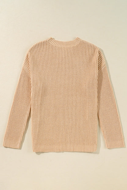 Side slit round neck long sleeve sweater in beige, ribbed texture, slightly stretchy.