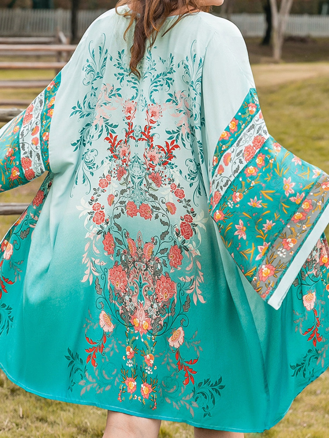 Plus size printed open front long sleeve cover up with floral design.