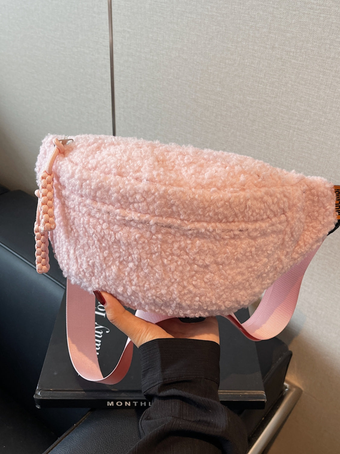 Pink sherpa crossbody bag with adjustable strap, medium size, polyester material.