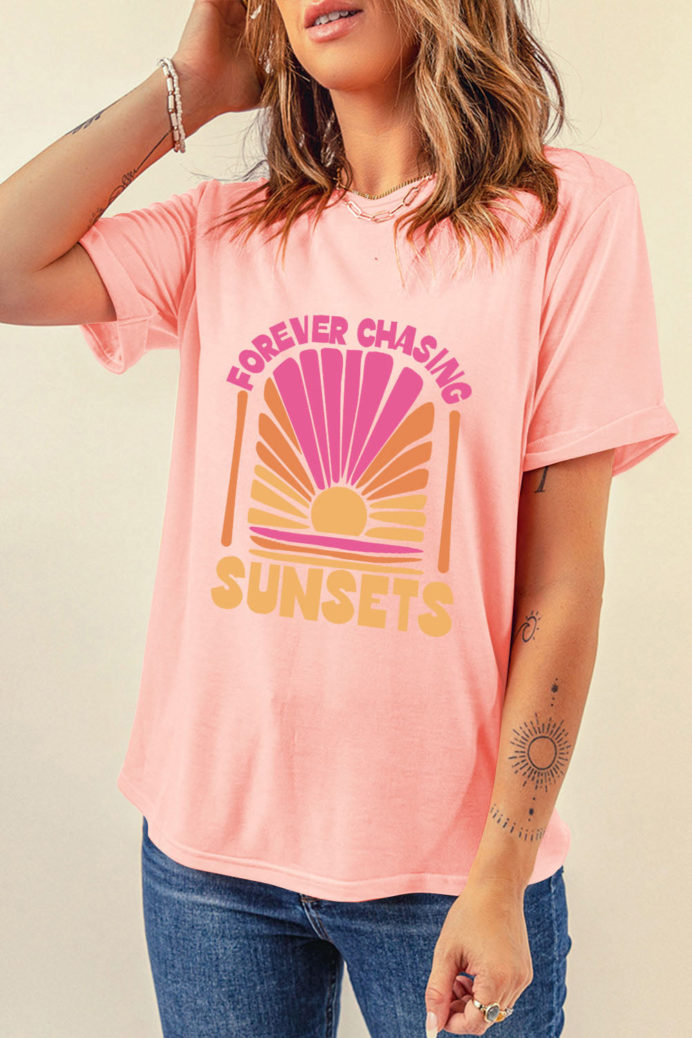 Forever Chasing Sunsets Graphic T-Shirt in pink worn by a model.