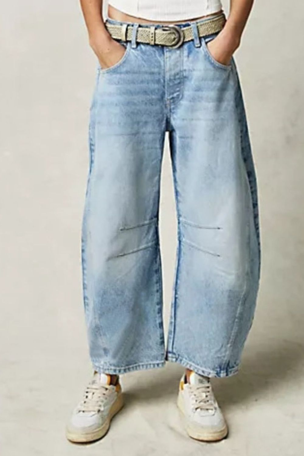 Wide leg barrel jeans with pockets and button detail.