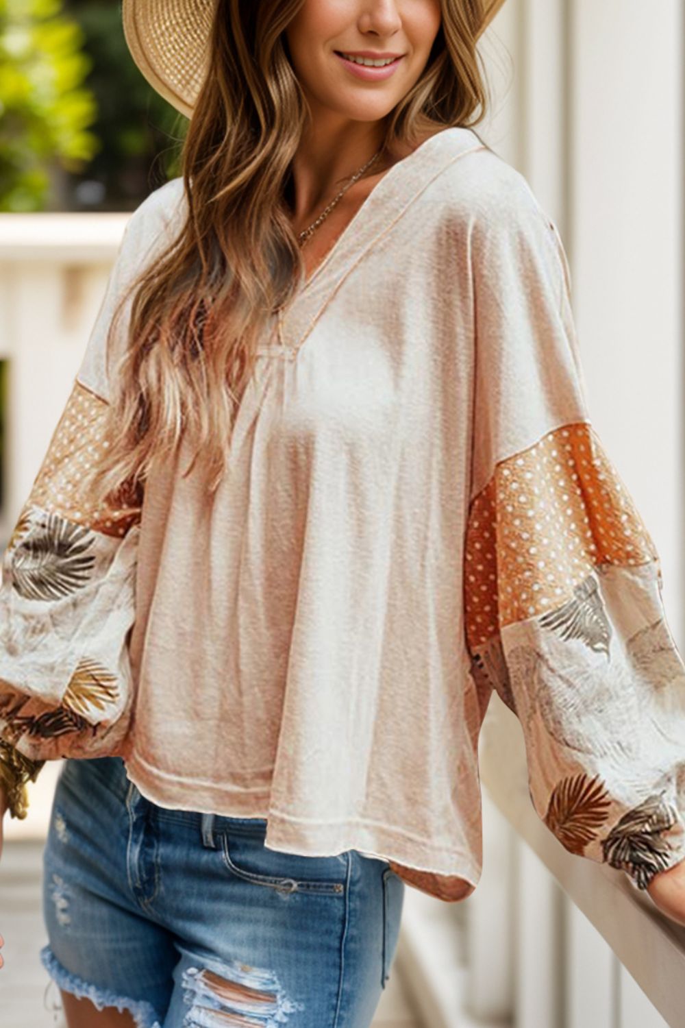 Printed V-neck long sleeve blouse with patchwork design, slightly stretchy, casual style.