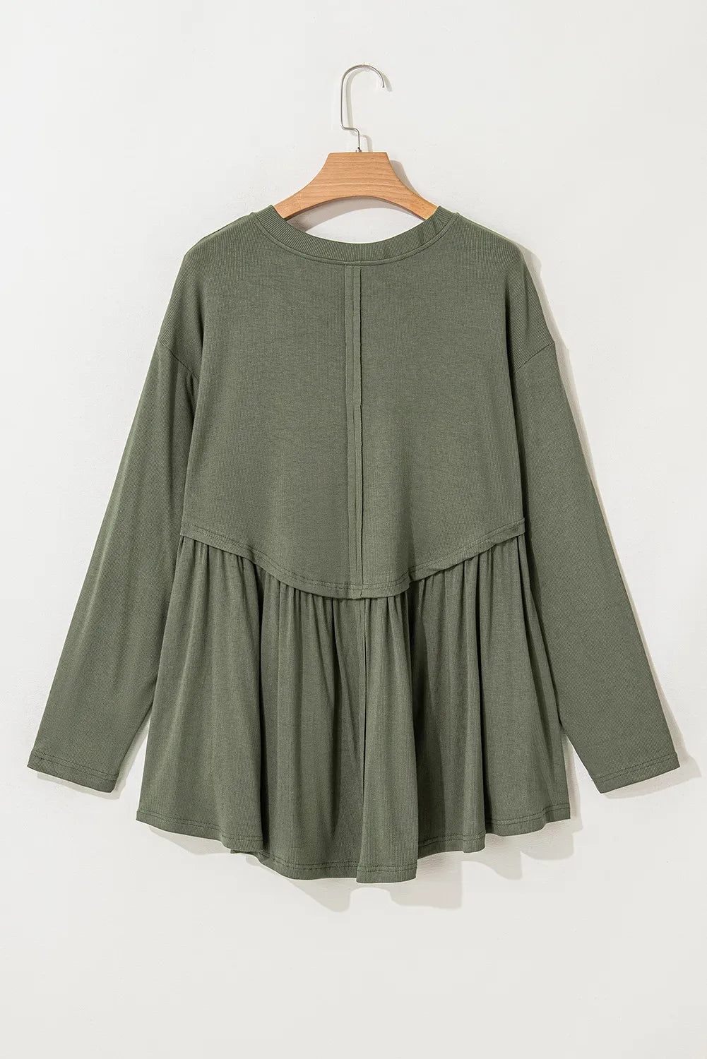 Plus size peplum round neck long sleeve blouse in olive green on hanger.