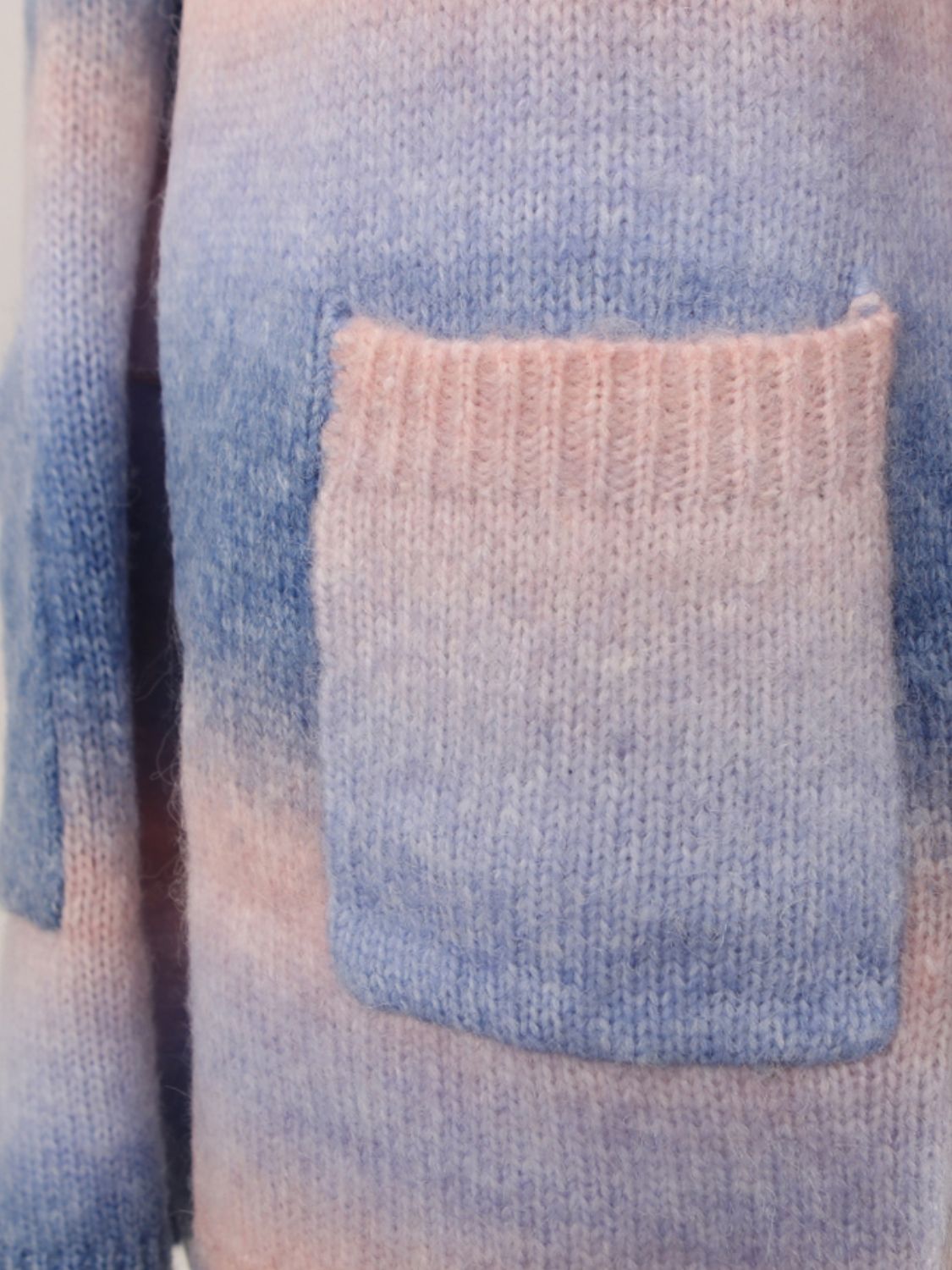 Gradient cardigan with pocket detail in pastel colors.