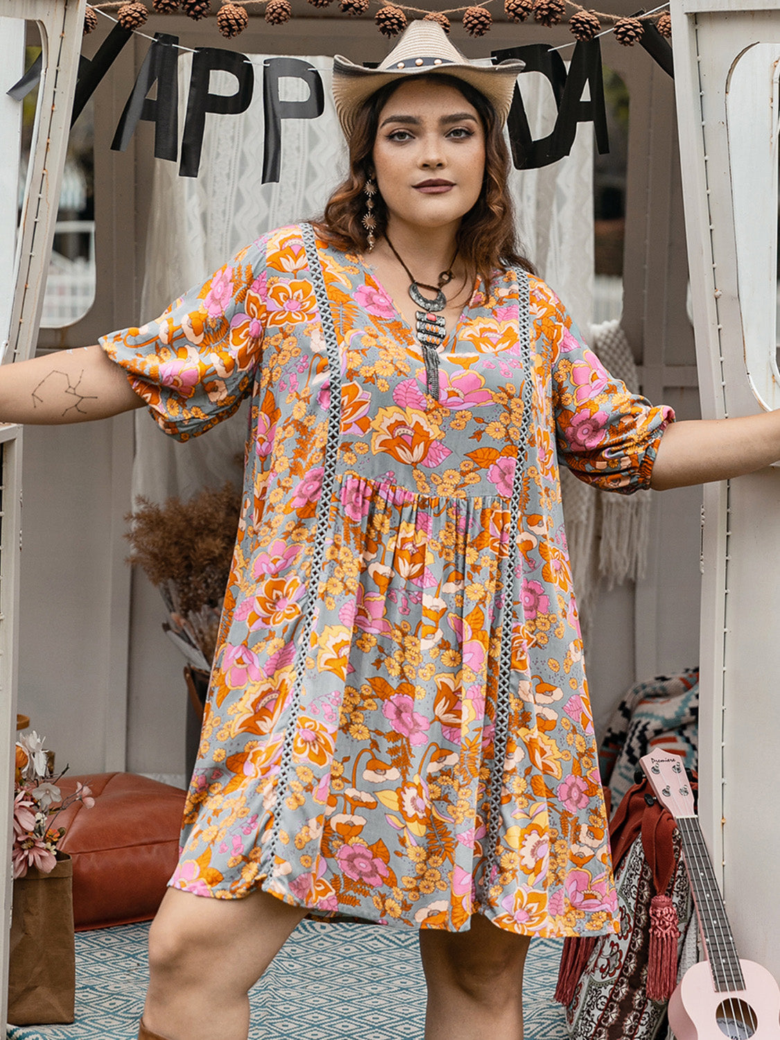 Plus size ruched printed half sleeve mini dress in colorful floral pattern.