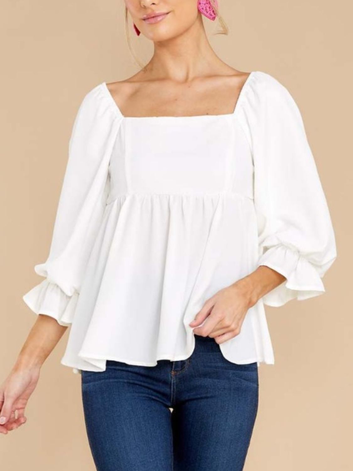 Smocked square neck flounce sleeve blouse in white with ruffled details.