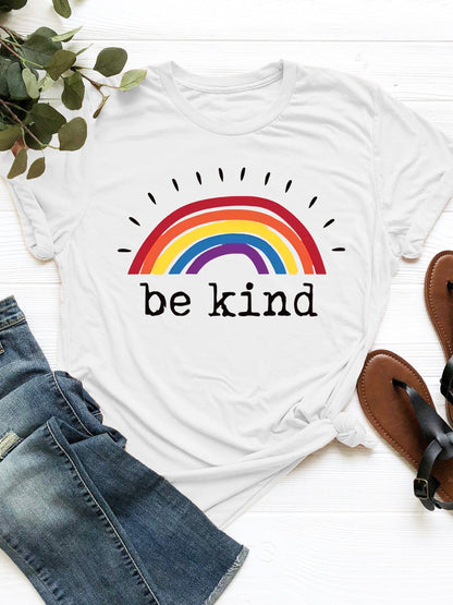 Be Kind Graphic T-Shirt with rainbow design on white fabric.