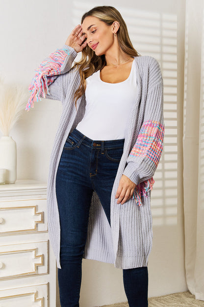 Boho style knit cardigan with woven fringe sleeves and dropped shoulders for women.