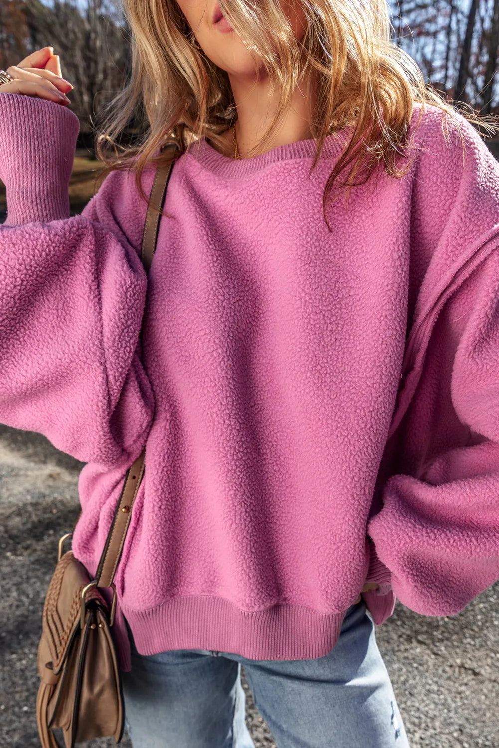 Slit round neck long sleeve pink sweatshirt, exposed seam, high-low hem.