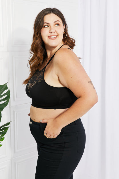 Plus-size model wearing a black Romantic Night Lace Cutout Bralette.