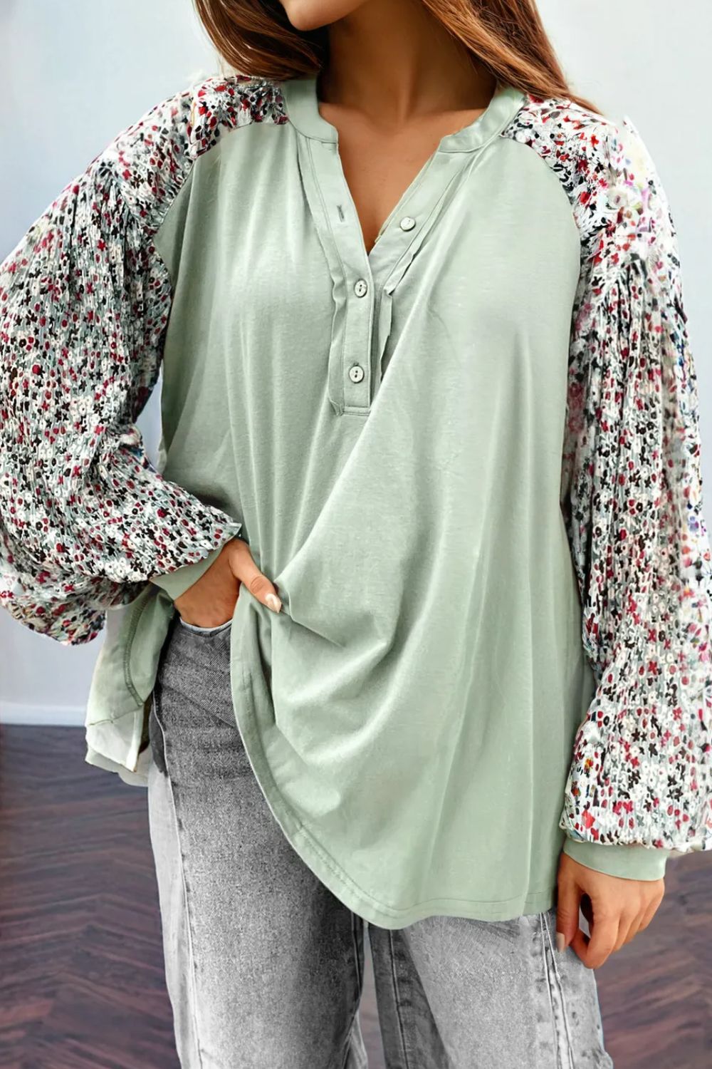 Floral printed notched long sleeve blouse in light green with buttoned front.