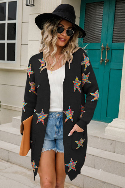 Woman wearing a Star Open Front Long Sleeve Cardigan with pockets and colorful star design, styled with denim shorts and a hat.