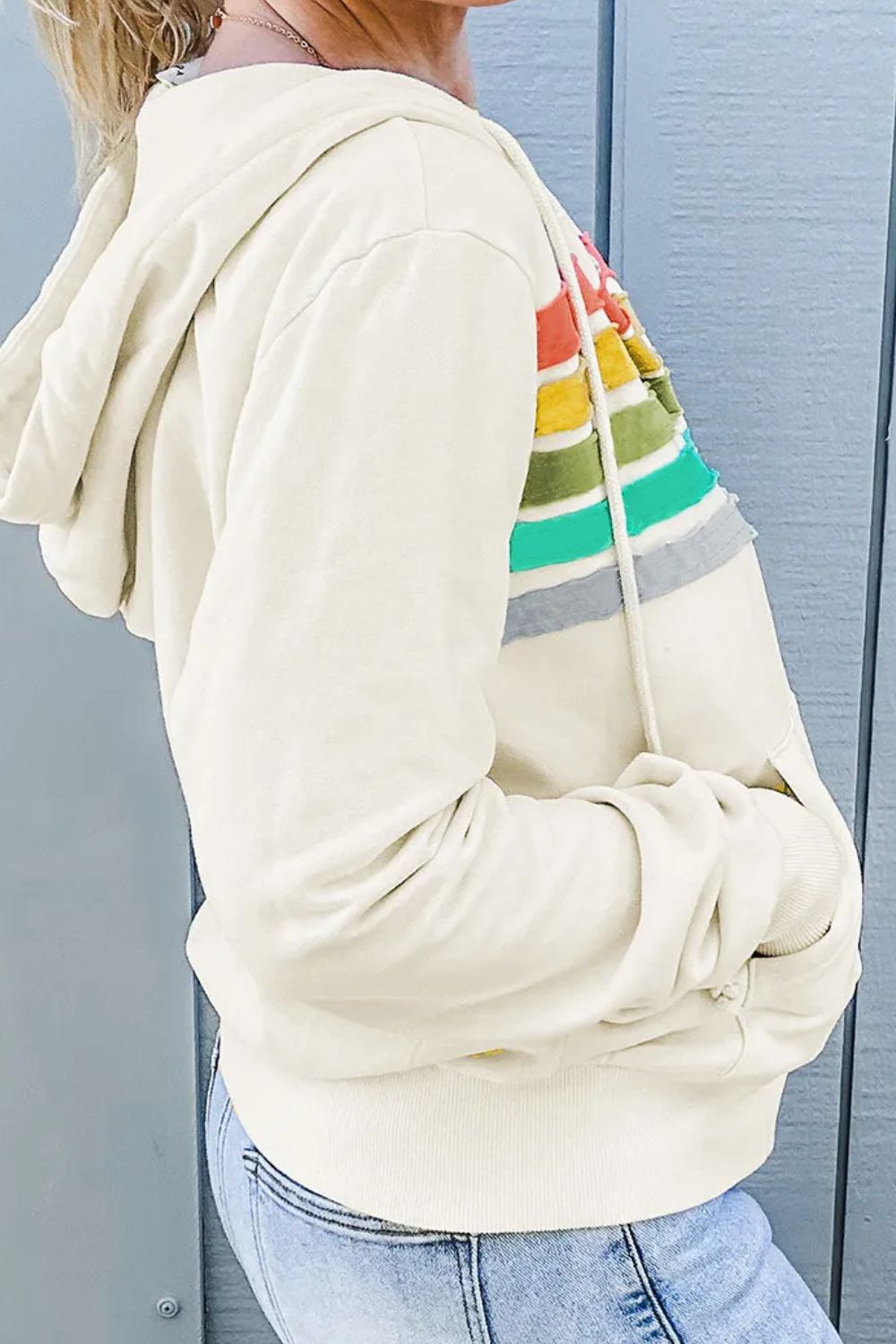 Rainbow hoodie with drawstring and zip-up design, featuring colorful stripes on the chest.