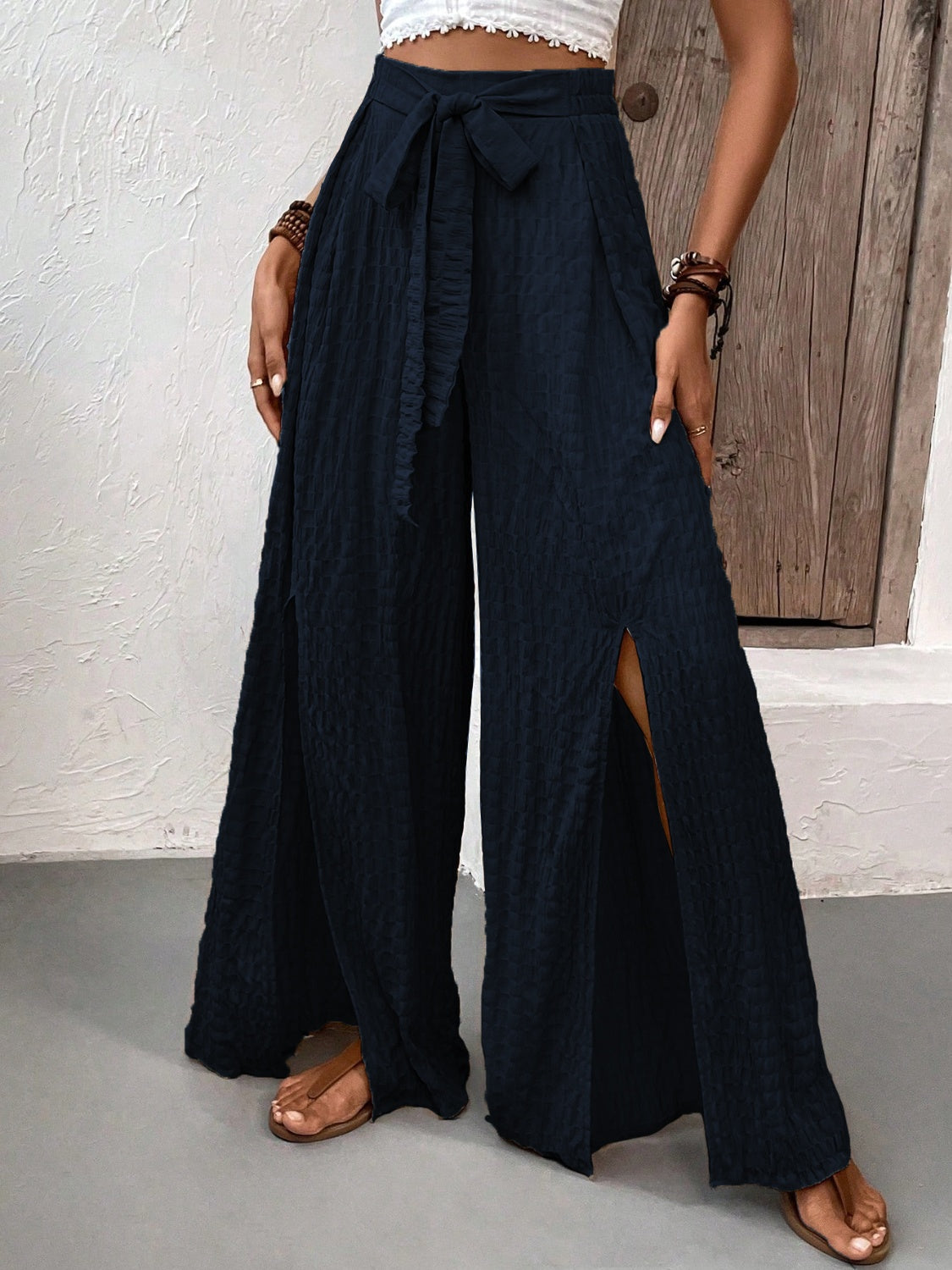 Honey Tied Slit Wide Leg Pants in navy, featuring front slits and a tie waist.