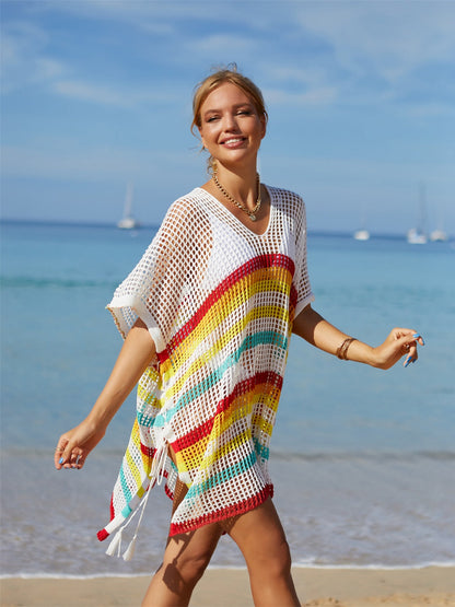 Rainbow cutout striped swim cover up with slit design, semi-sheer material, and moderate stretch on the beach.