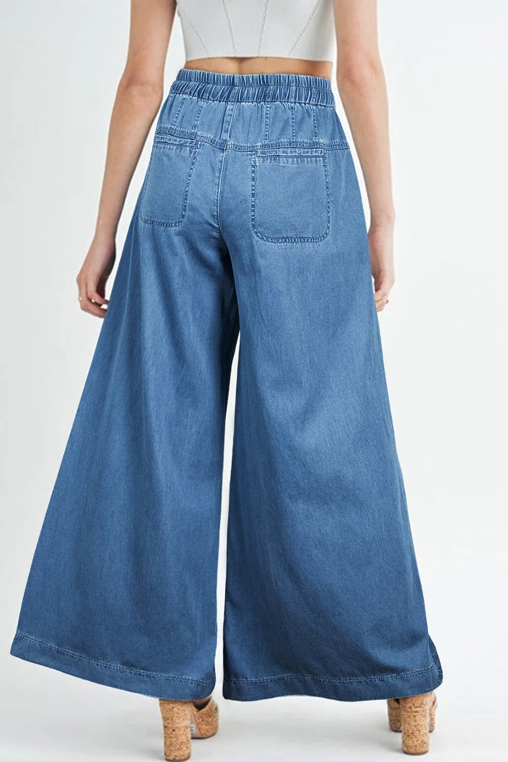 Drawstring elastic waist wide leg jeans made of 100% cotton, shown from the back with wide leg design and back pockets.