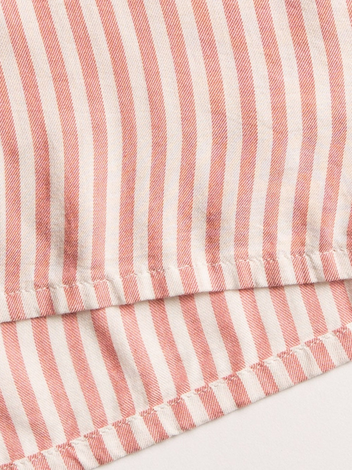 Striped fabric detail of collared neck long sleeve top.