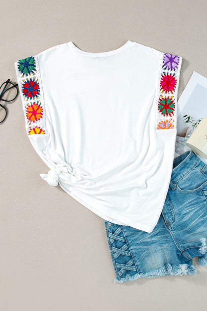 Boho colored cap sleeve top with basic style and embroidered shoulder detailing.