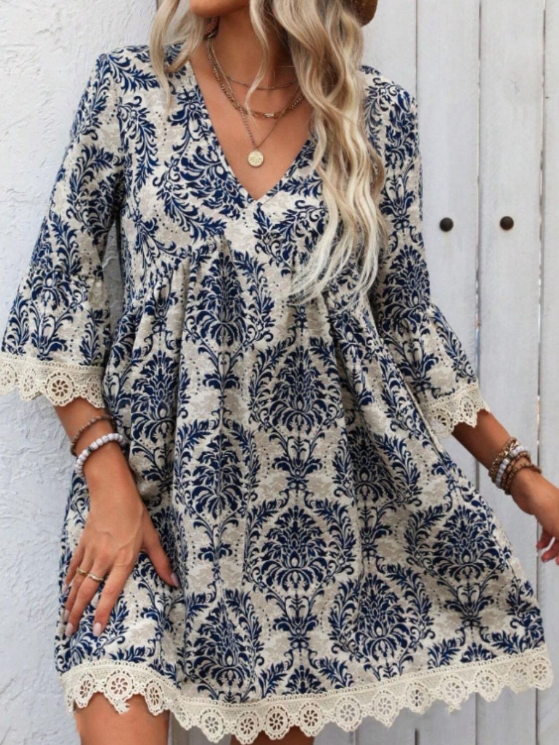 Lace detail printed V-neck mini dress with floral pattern.