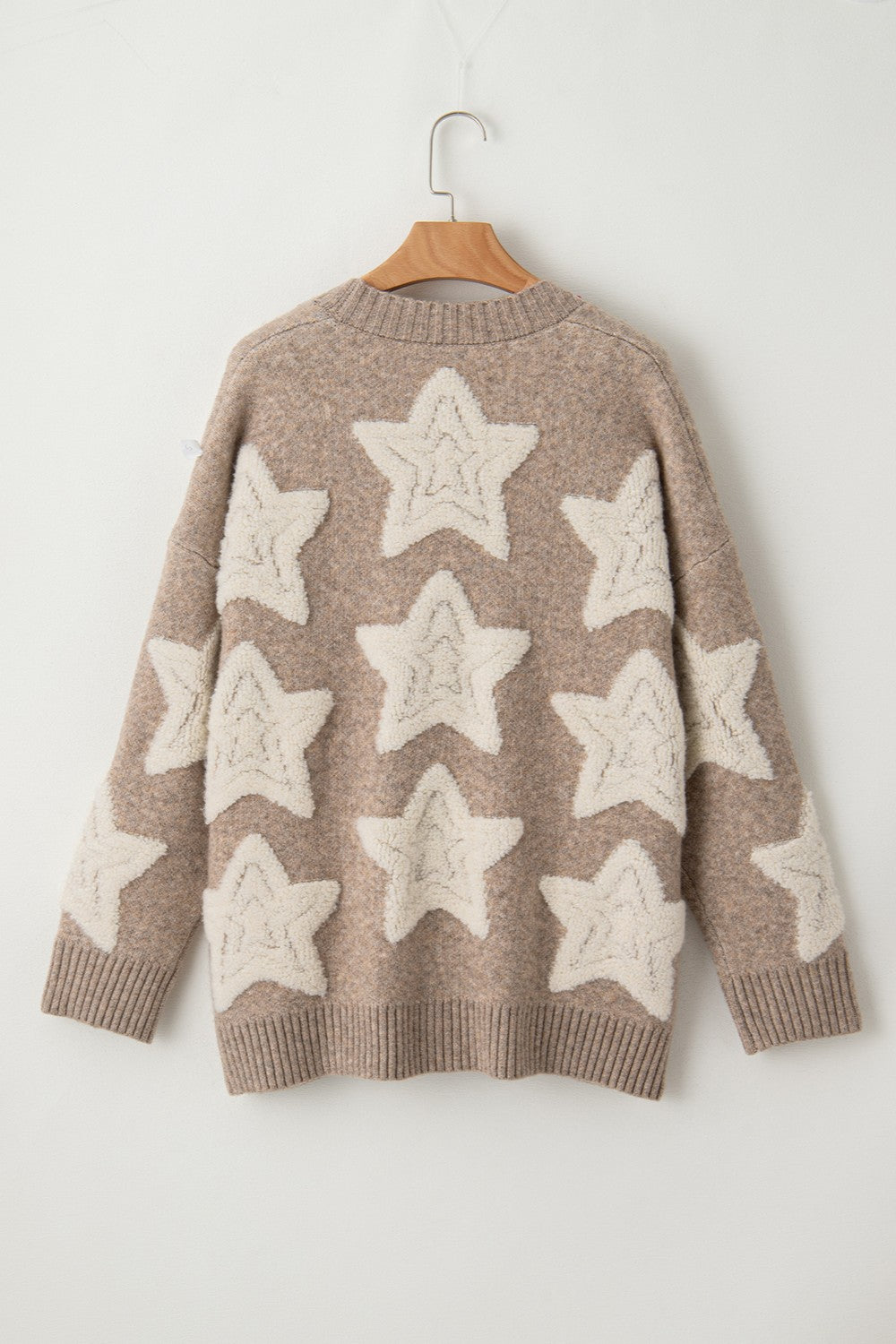 Star print button-up cardigan with pockets, slightly stretchy material, acrylic and polyester blend.