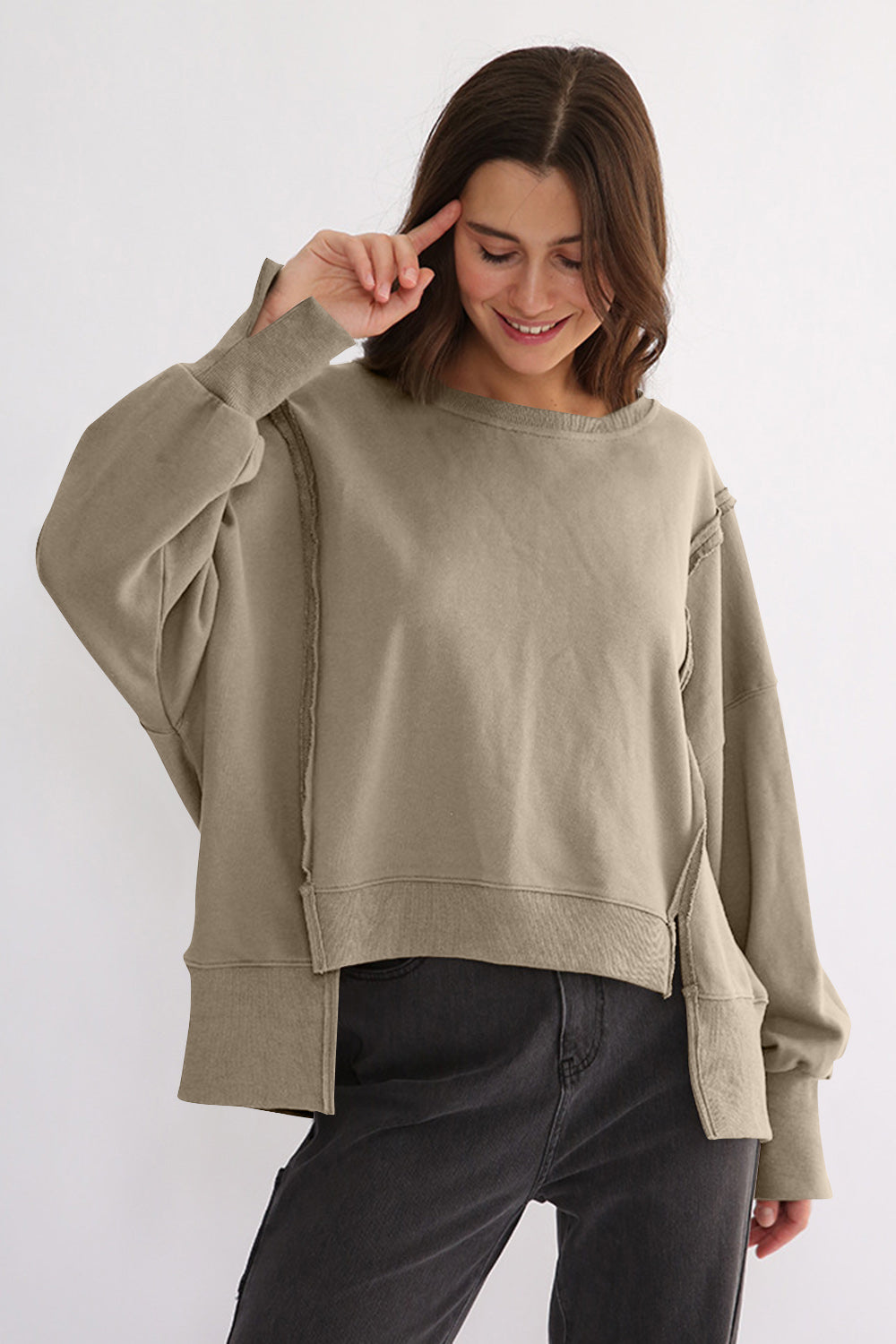 Exposed seam high-low sweatshirt, 100% cotton, long sleeves, casual style.