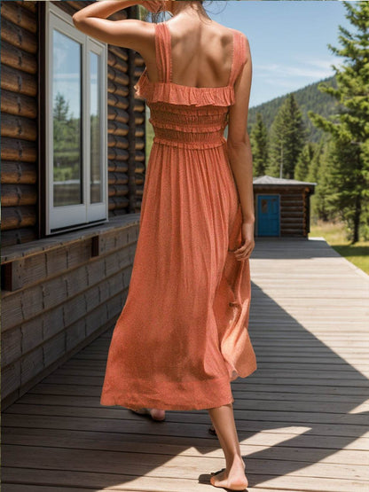 Frilled square neck wide strap dress in orange with a tied design, worn outdoors.