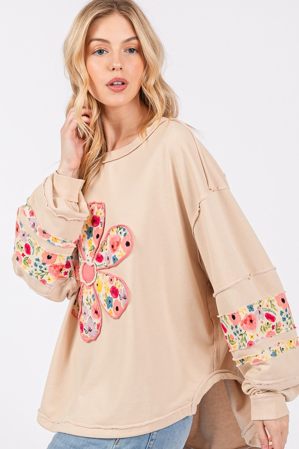 Daisy Patch Applique Long Sleeve Sweatshirt with floral design and exposed seam detail.