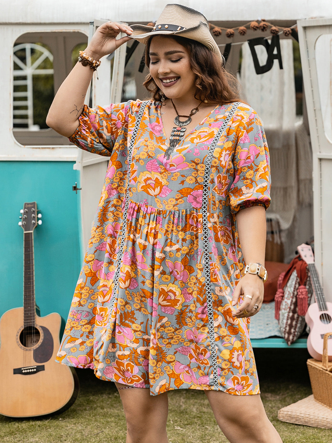 Plus size ruched printed half sleeve mini dress in floral pattern.