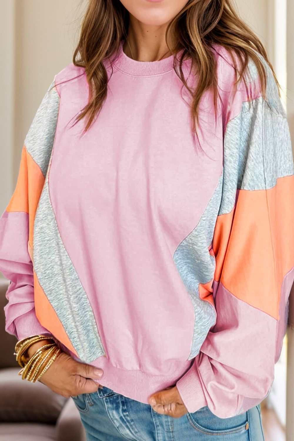 Color block round neck long sleeve sweatshirt in pink, gray, and orange.