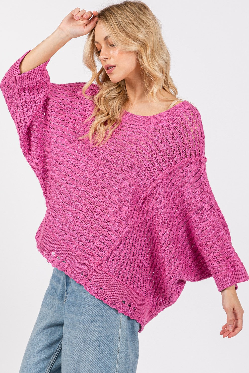 Distressed asymmetrical open stitch magenta sweater with half sleeves and round neckline.