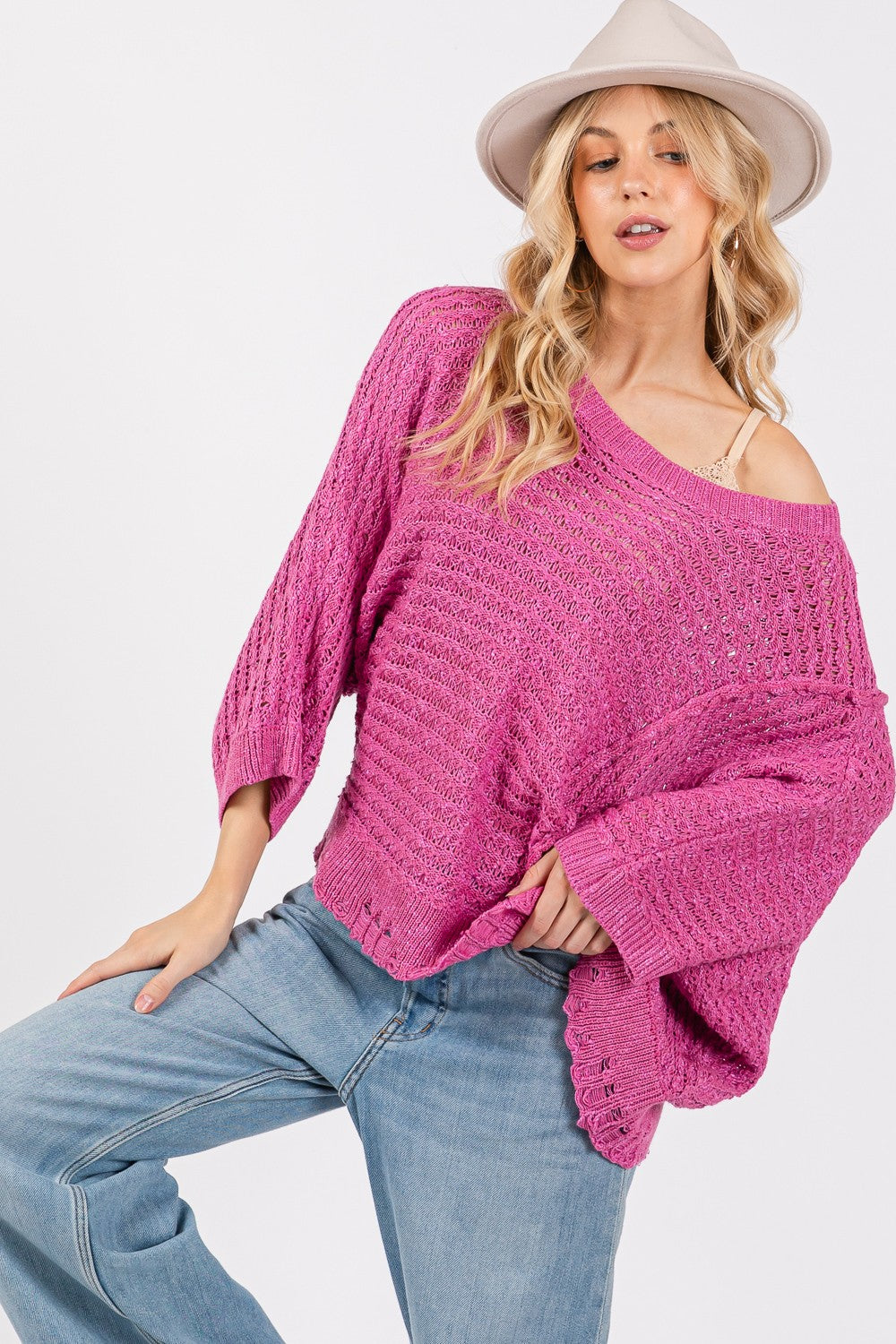 Distressed asymmetrical open stitch magenta sweater with half sleeves.