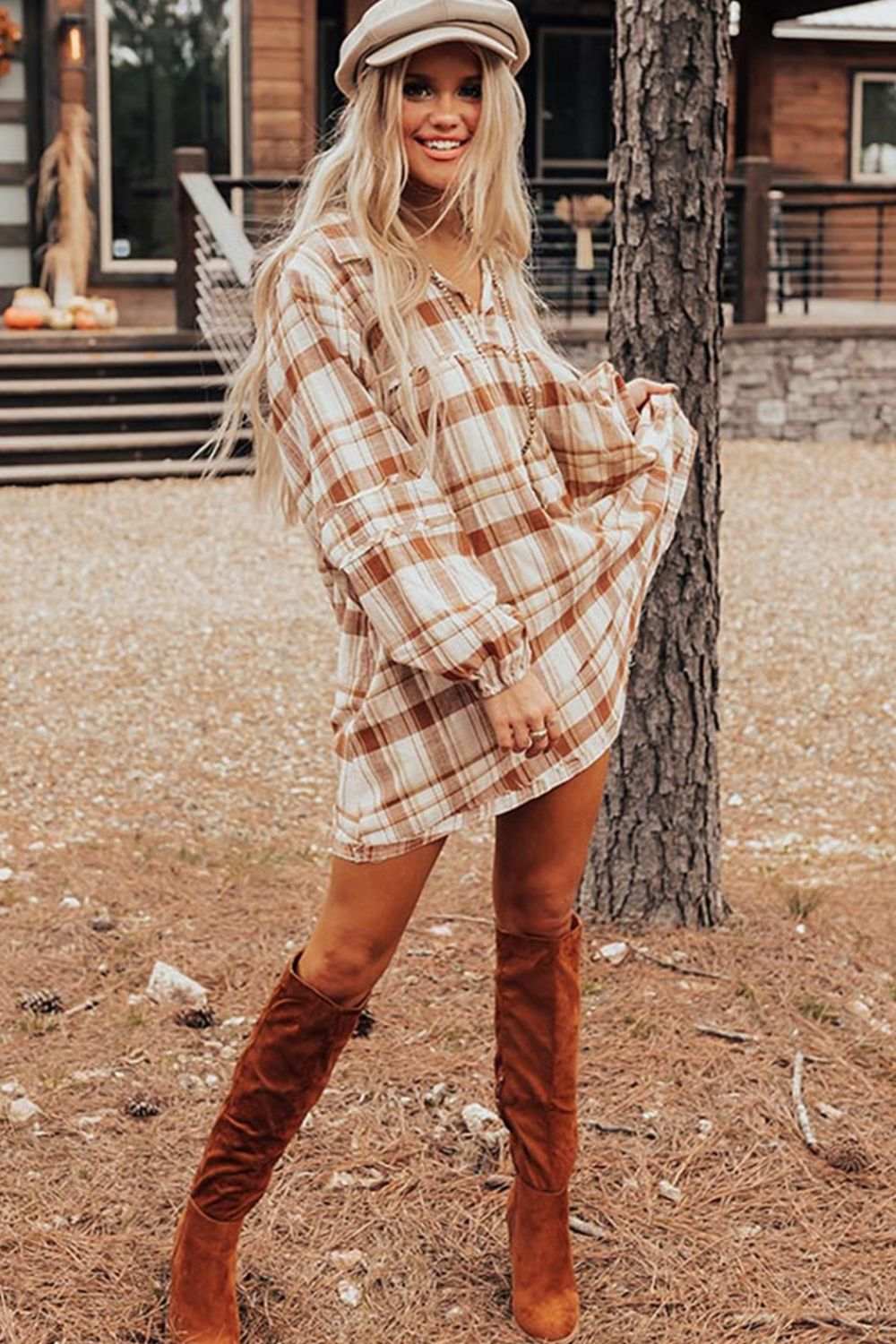 Plaid collared neck long sleeve mini shirt dress in beige and white with suede knee-high boots.